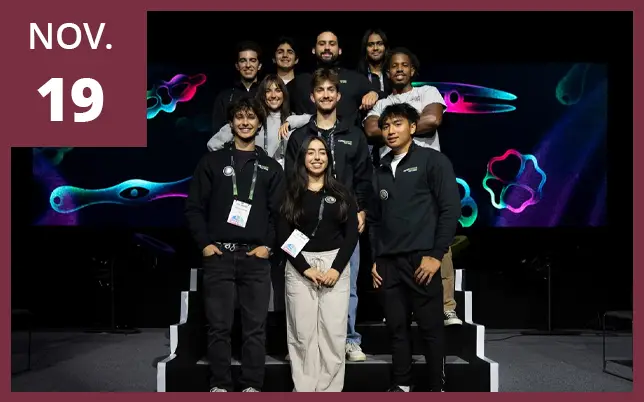 A group of ten researchers is shown on stage, following a scientific conference.