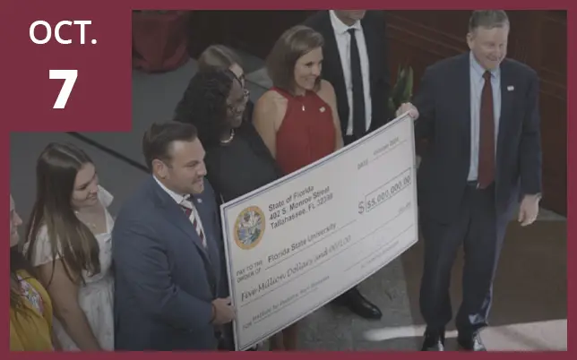 A group of legislators unveiling five million dollar check for IPRD with the text 