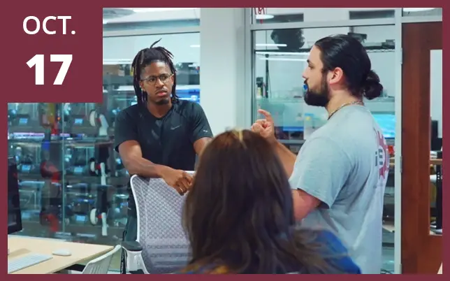 Researchers are seen in a lab or office environment discussing project strategies.