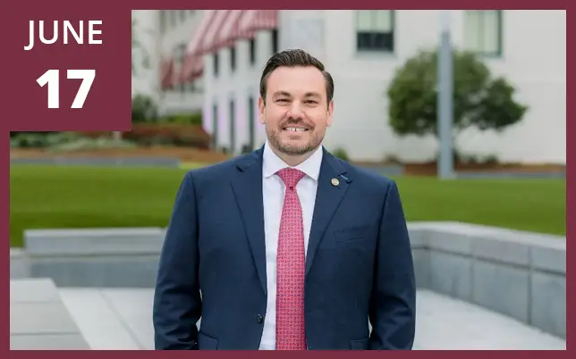 Representative Adam Anderson wearing a dark suit and tie, smiling at the camera. A maroon box in the top-left corner features the text 