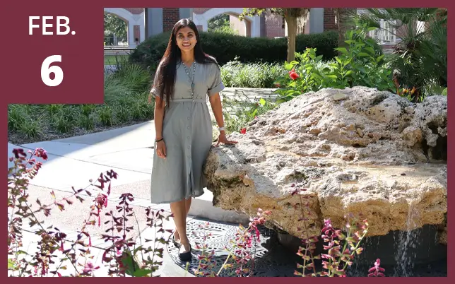 Saanchi stands smiling on a sunny campus, wearing a light gray dress, with greenery, flowers, and brick arches behind her with the text 